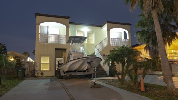 A two-story house with a boat parked in the driveway. - South Padre Island Spacious!!! 3 Bedroom 2 Bath #2015-837252 (South Padre Island)