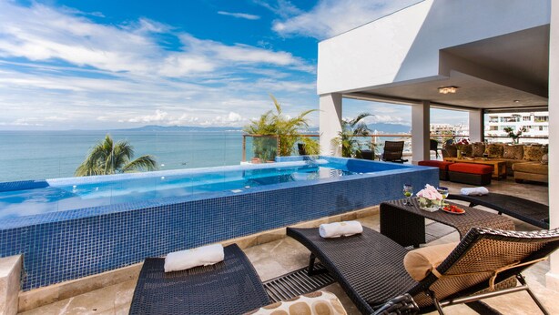 A modern outdoor pool area with lounge chairs and a view of the ocean. - Best location right on los muertos beach, Sky Suite E (Amapas)