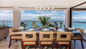 A dining area with a table set for six, overlooking a scenic ocean view. - Best location right on los muertos beach, Sky Suite E (Amapas)