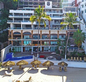 A multi-story hotel with a pool area, palm trees, and outdoor seating. - Best location right on los muertos beach, Sky Suite E (Amapas)