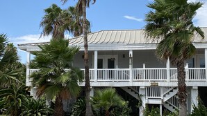 Een huis met twee verdiepingen, een balkon en een trap naar de bovenverdieping.