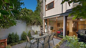 A modern house with a glass door leading to a patio area. - Fitzgeorge - spacious home in inner Fitzroy Melbourne perfect location (Fitzroy)