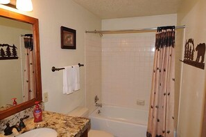 A bathroom with a sink, mirror, and bathtub. - Very nice Condominium in an excellent location! (West Yellowstone)