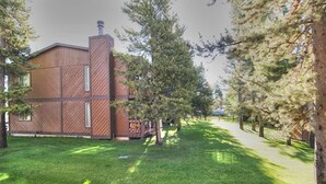 Un bâtiment au design moderne, doté d’une grande cheminée et d’une façade en bois.