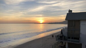A beach view with a building that has a balcony overlooking the ocean. - Sunset Malibu Road Premium Ocean Front Penthouse (Malibu)