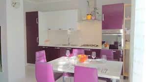 A modern kitchen with white cabinets, a gas stove, and a glass shelf with plants. - Apartment Laura, Viškovići, Koromačno, Istra ! near the sea!!   (Koromačno)