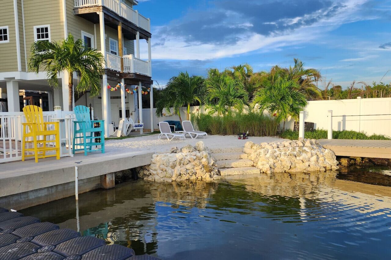 A pool area with lounge chairs and a small water feature.
