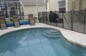 Relax by the pool surrounded by comfortable lounge chairs.