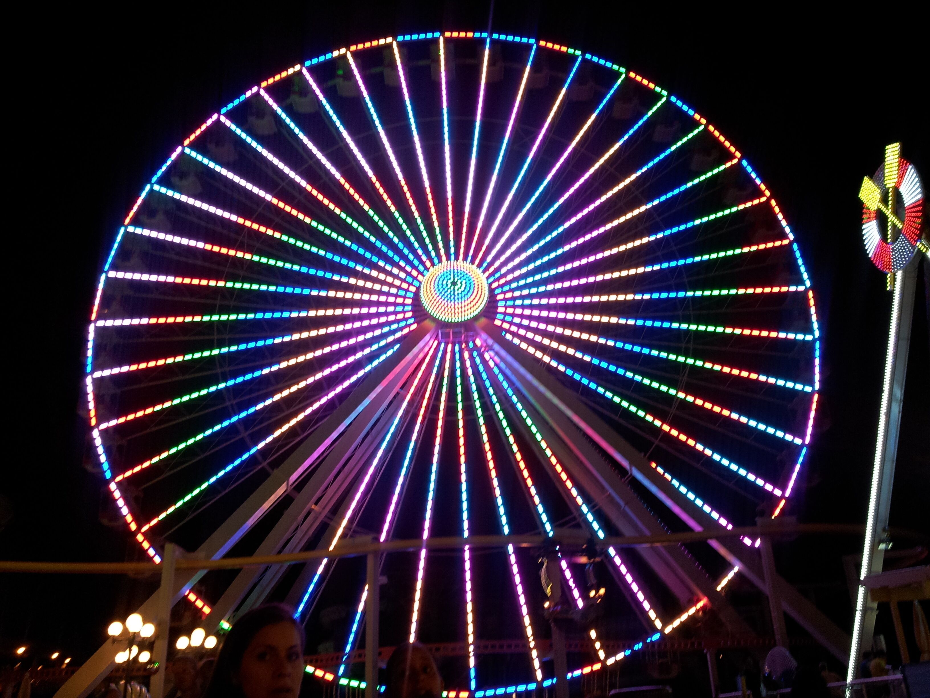 A large Ferris wheel with colorful lights.