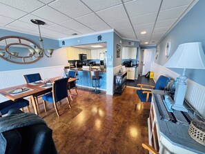 Relax in this stylish room with a dining area, seating area, and kitchenette.