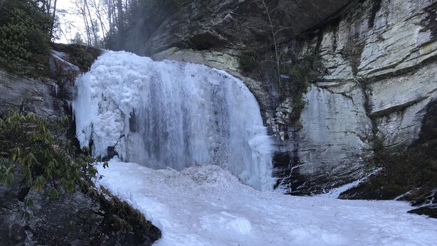 A waterfall cascading over a rocky cliff surrounded by snow. - Dreamy Cottage for Two (Brevard)