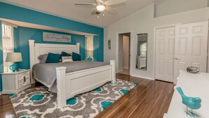A bedroom with a white bed, teal walls, and a ceiling fan. - Tropical Perfection!  3 BR/2 BA & HEATED POOL! Close to beaches, WiFi (Sebastian)