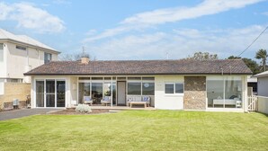 A two-story house with a tiled roof, large windows, and a front porch with seating. - BOWERBIRD VIEW - Breathtaking Ocean Views (Busselton)