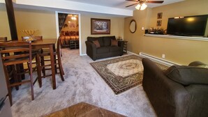 A living room with a dining area, a ceiling fan, a flat-screen TV, and a fireplace. - Cozy guest apartment conveniently located to all Woodland Park attractions (Woodland Park)