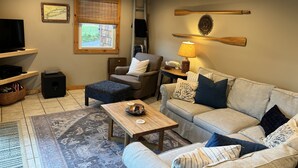 A cozy living room with a ceiling fan, a television, a fireplace, and a comfortable seating area. - Quiet cove, deep water, minutes to Clemson, pet friendly, easy path to the dock (Seneca)