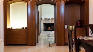 A room with a wooden arched doorway leading to a fireplace area with a marble mantelpiece. - Spacious Villa with Pool in Puglia for 8 people  (Putignano)