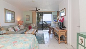 A room with a bed, a sofa, a dining table, and a view of the ocean. - Playa Linda - St. Thomas Oceanfront Studio Condo at Pool & Bolongo Beach, USVI (St. Thomas)