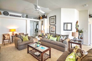 A living room with two sofas, a coffee table, and a ceiling fan. - Cozy Lake Havasu City Retreat w/ Deck & Pool Table (Lake Havasu City)