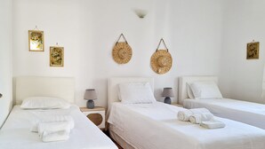 A hotel room with two beds, white bedding, and two wall-mounted lamps. - My Home in Naxos Town With Sea View (Naxos)