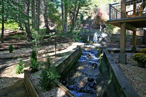 A soothing mountain runoff stream runs past the door and under the deck