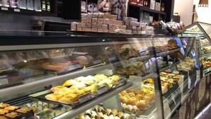 A bakery display case with various baked goods. - Meko - Luxury Carlton House in Melbourne golden inner city (Carlton)