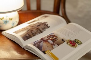 An open magazine with a photograph of a building and a person. - Authentic And Lovely Trulli In Monopoli’s Countryside (Monopoli)