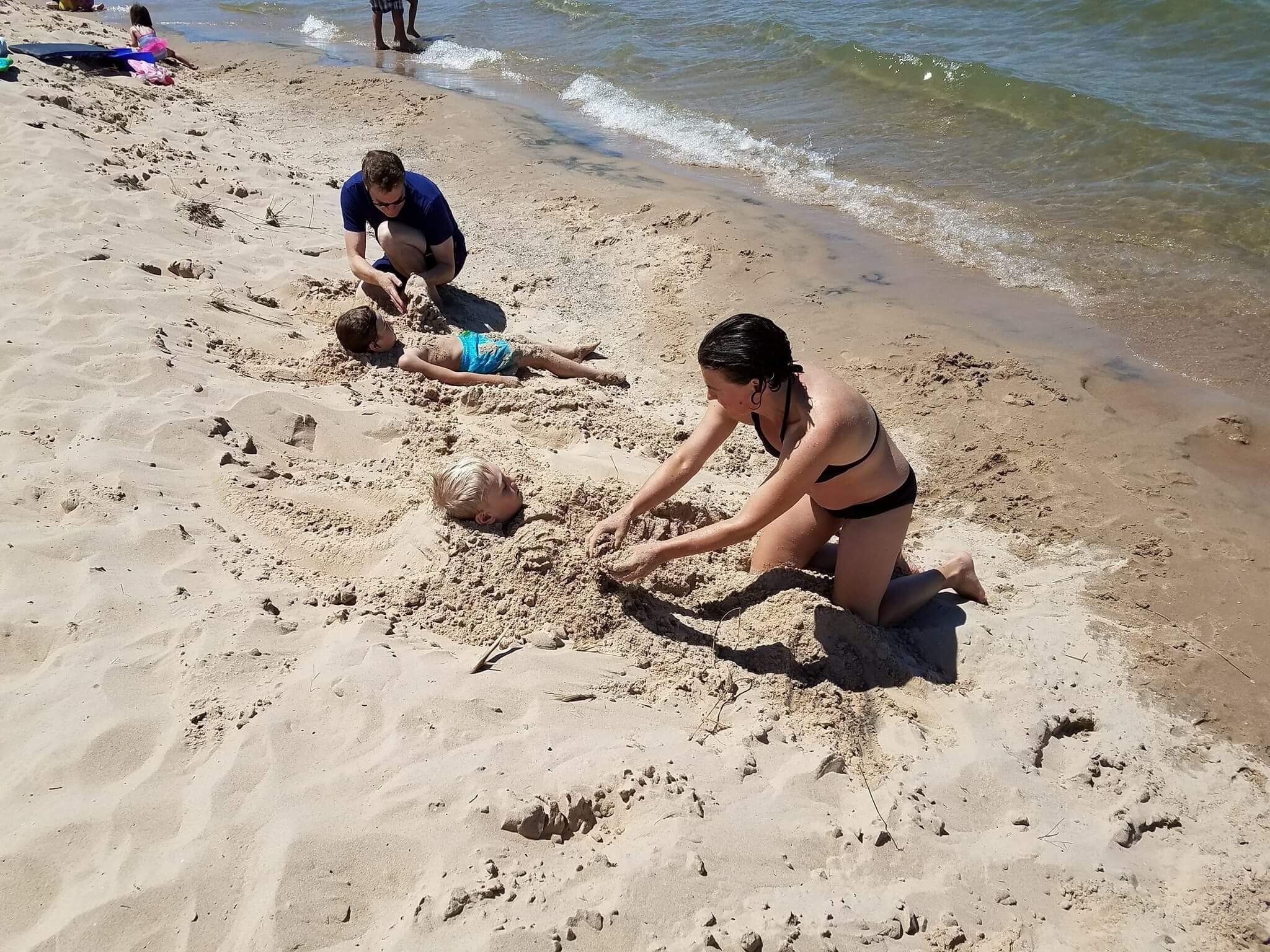 A sandy beach with people engaged in activities.