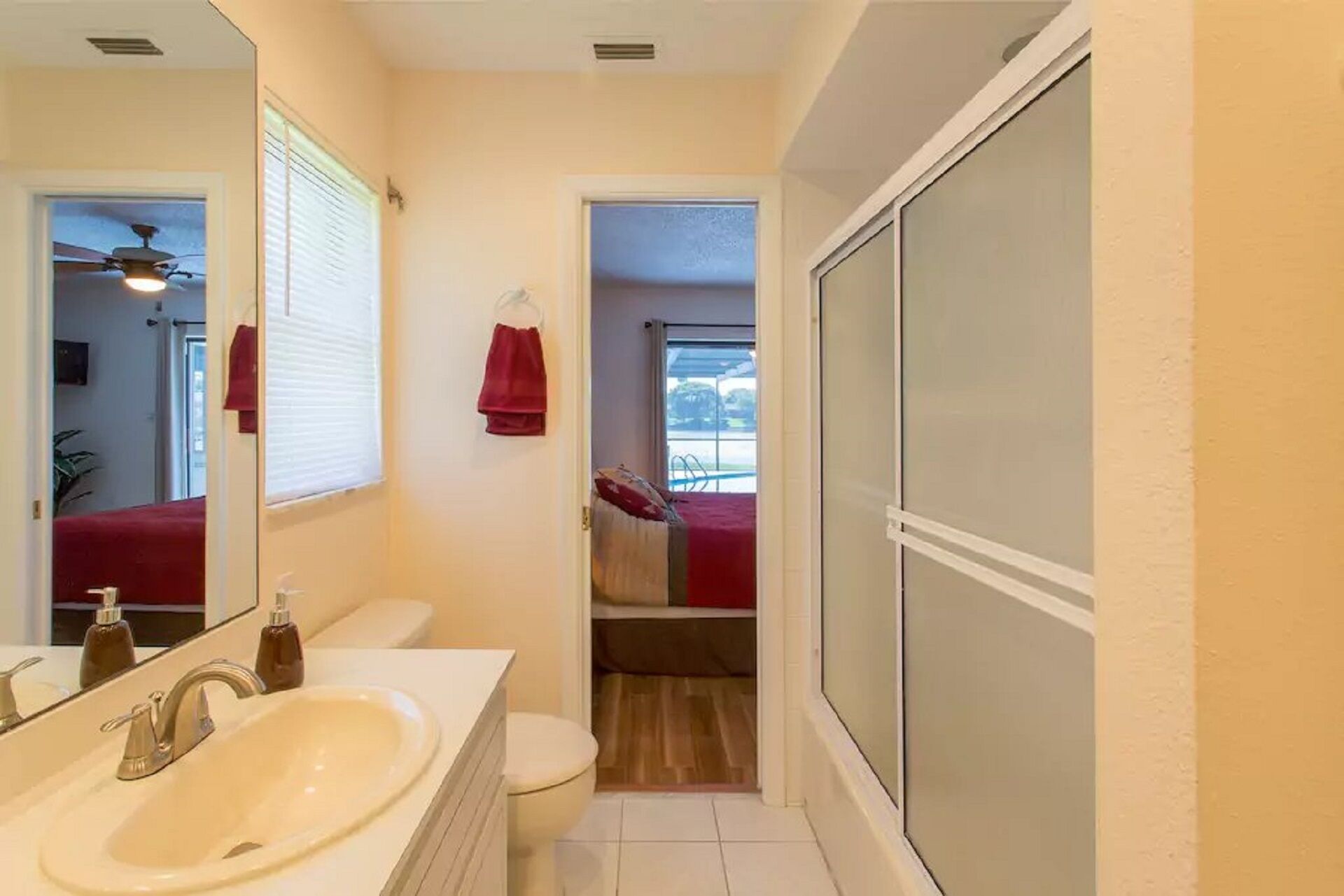 A bathroom with a white sink, a toilet, and a shower area.