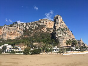 A coastal landscape with a prominent rocky cliff and a building with arches on top. - Villa  'Ai Galli' - your Nature Paradise on the Mediterranean sea (Terracina)
