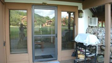 Enjoy outdoor dining and cooking on the deck with a grill and table.