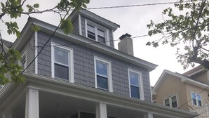 A two-story house with a stone foundation, white railings, and a front porch. - Almost Beachfront, 7 houses to the Beach (Ventnor City)