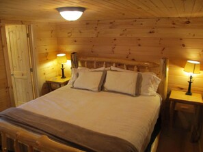 Relax in a comfortable bedroom with a large bed, two bedside tables, and ample lighting.