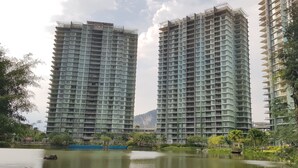 Two high-rise residential buildings with balconies, surrounded by greenery and a body of water. - Prime apartment in Haven Ipoh  (Ipoh)