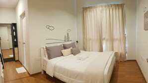 A neatly arranged bedroom with a bed, pillows, and a bedside table. - Prime apartment in Haven Ipoh  (Ipoh)