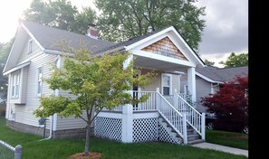 Stroll up to this charming two-story home with a welcoming front porch and beautifully manicured lawn.
