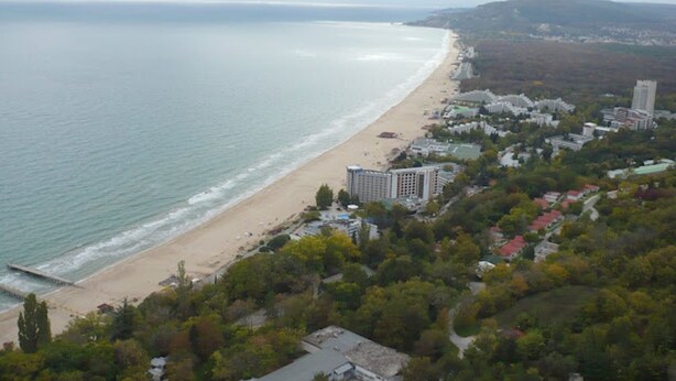 A coastal view with a beach, buildings, and a hilly landscape. - Clean Nature & Beautiful View (Balchik)