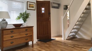 A wooden dresser with drawers, a vase, and a plant on a windowsill. - Perfect for walkers, Goodwood, National Trust, Short Stay (Bramshott Chase)