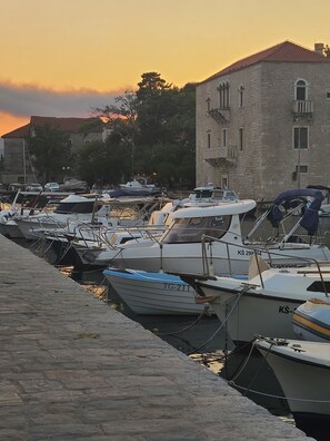 A marina with boats docked, a stone building with windows, and a cobblestone walkway. - Waterfront Dalmatian Stone Villa with Panoramic Adriatic Views, Kastel Novi (Kaštel Novi)