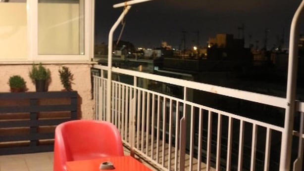 A balcony with a white railing, a red chair, and a small table. - Private 6th floor apt!Double bed and Acropolis view!!In the center of Athens (Athens)