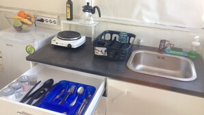 A kitchen with a microwave, a fruit bowl, a coffee maker, a sink, and a drawer with utensils. - Private 6th floor apt!Double bed and Acropolis view!!In the center of Athens (Athens)