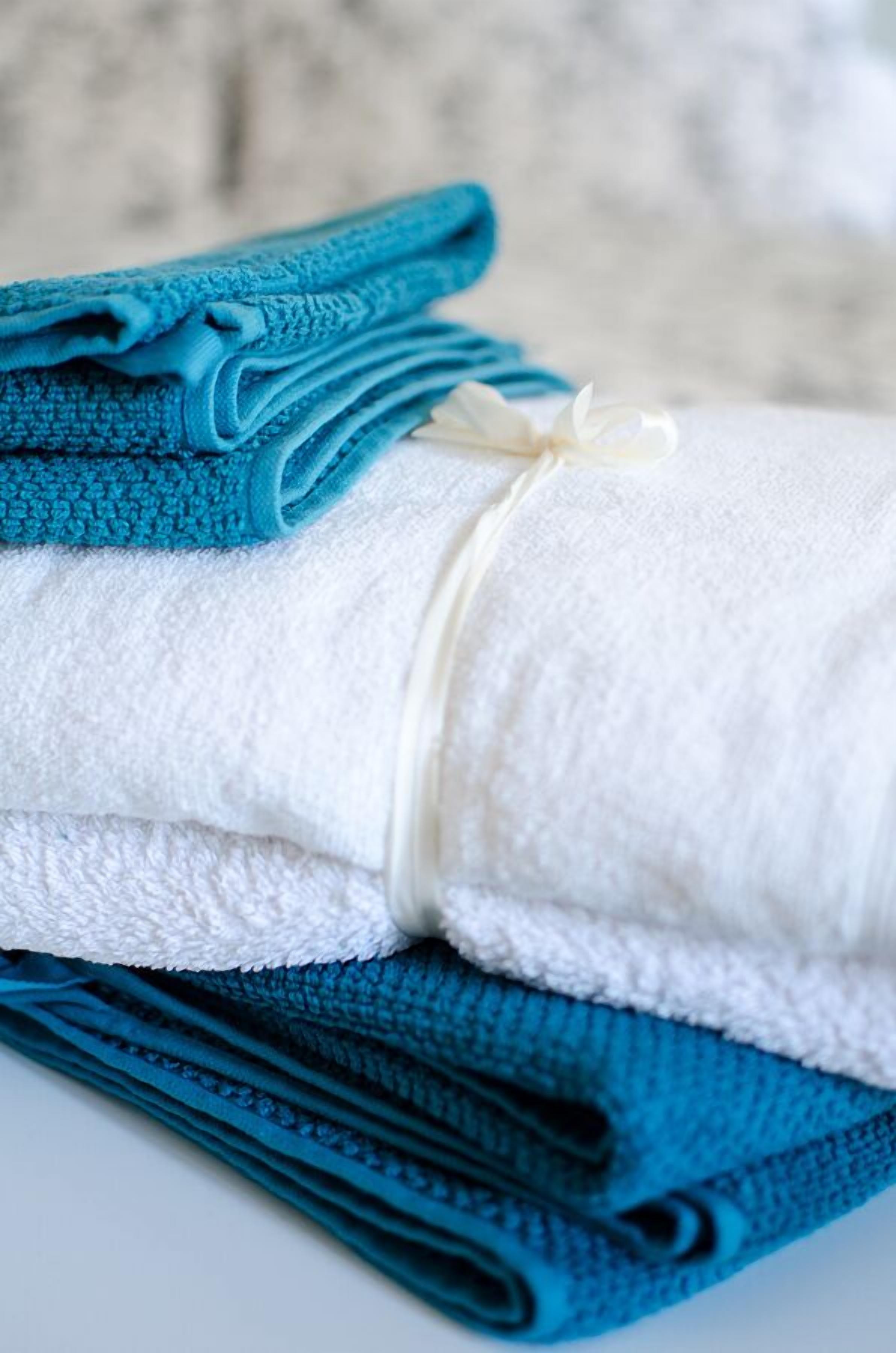 A stack of folded towels in blue and white.