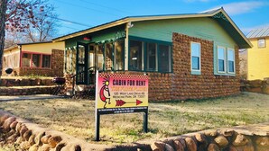 A cabin for rent with a sign indicating it's available for reservations.