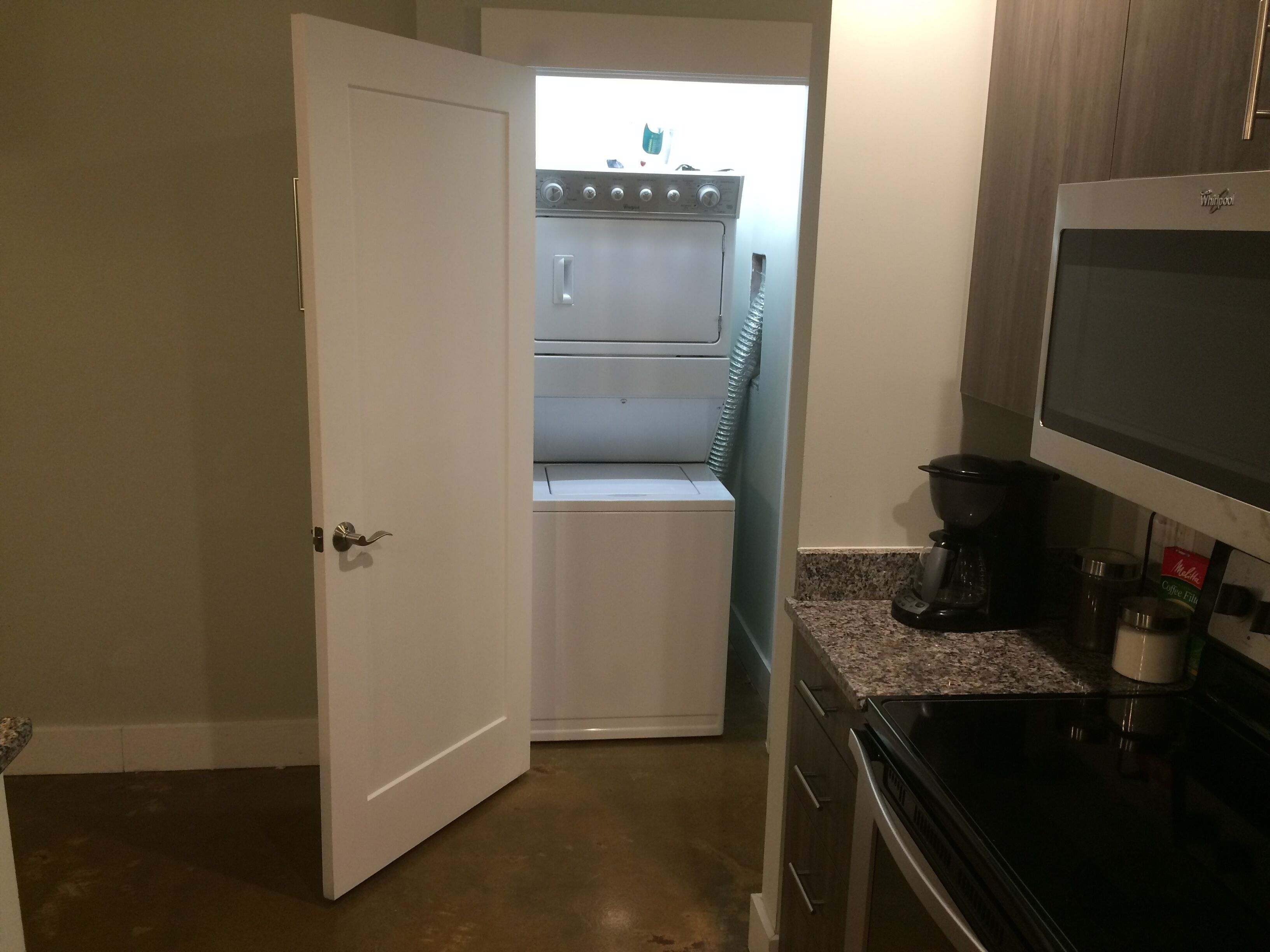 A compact kitchen with a built-in oven, a microwave, and a coffee maker.