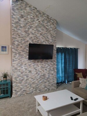 Relax in this inviting living space with a flat-screen TV and comfortable seating area.
