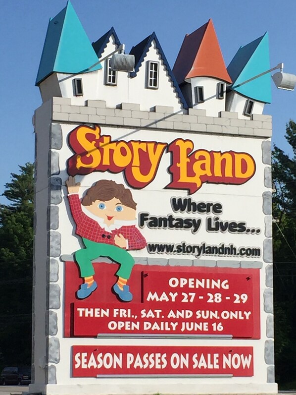 A sign for Story Land with a cartoon character, indicating a theme park or attraction.