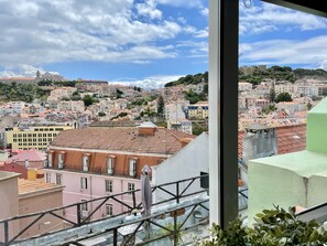 A cityscape with a view of buildings, a bridge, and a castle in the distance.
