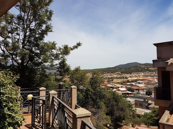 A residential area with houses, trees, and a distant mountain range.