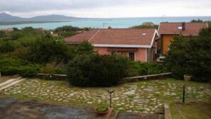 A coastal property with a stone pathway leading to a house with a red-tiled roof. - House / Villa - STINTINO (Stintino)