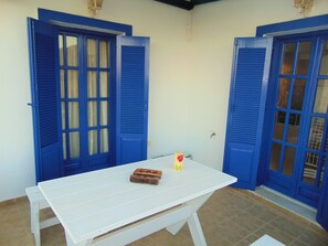 A white table with two blue doors in the background.