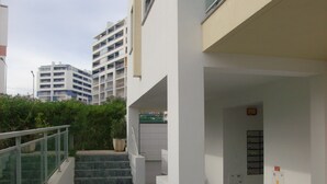 A building with a staircase leading to a landing with a glass railing. - excellent for families (Portimão)